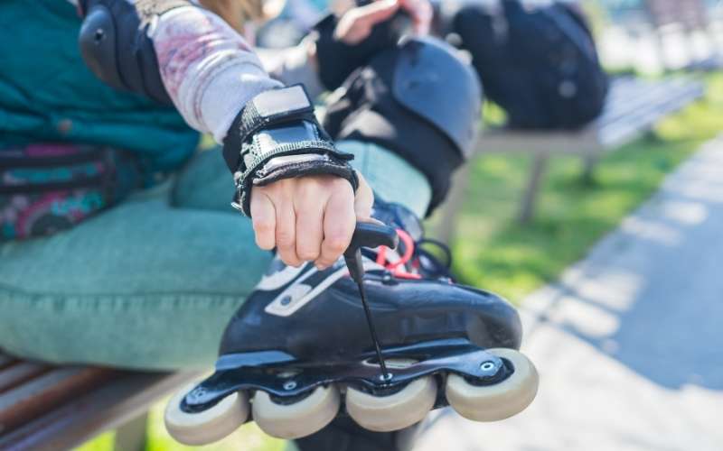 Inline skater adjusting an axle screw