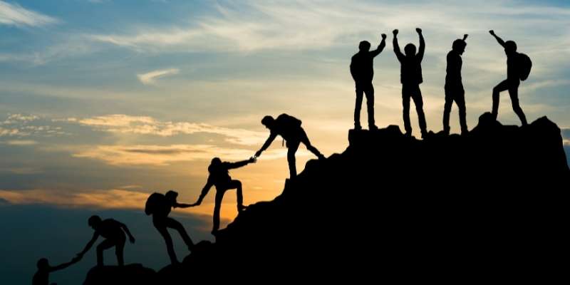 People Climbing a Mountain Together