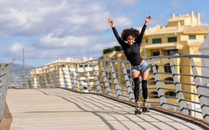 Woman Roller Skating on Bridge