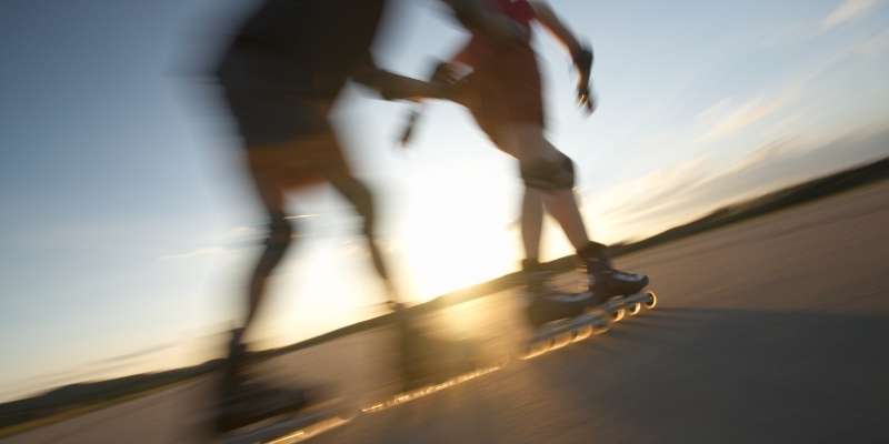 Two people inline skating outdoors